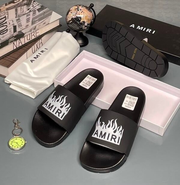 Amiri slides feature a prominent white flame graphic and brand logo on the strap